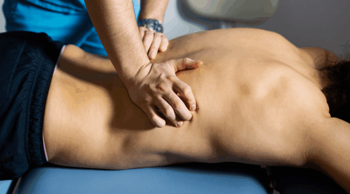Close up of Physical Therapist Massaging Lower Back