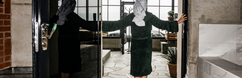 A woman stretches in the doorway of a spa